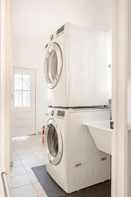 two washing machines stacked on top of each other in a kitchen at Cozy 3-Bedroom Home in K-town Los Angeles in Los Angeles