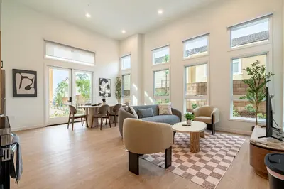 a living room with a couch and a table at The Village Collection with Gym Pool and Spa in Montclair
