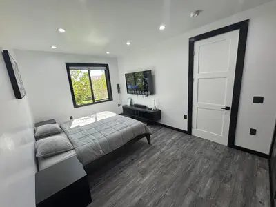 a bedroom with a bed and a window and a door at Burbank - Starlight Hills Private Luxury Guest House in Burbank