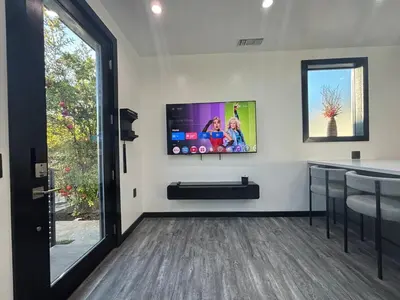 a living room with a flat screen tv on a wall at Burbank - Starlight Hills Private Luxury Guest House in Burbank