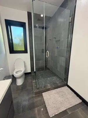 a bathroom with a glass shower with a toilet at Burbank - Starlight Hills Private Luxury Guest House in Burbank