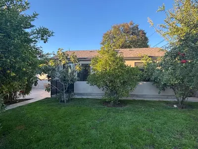 a house with two trees in a yard at Burbank - Starlight Hills Private Luxury Guest House in Burbank