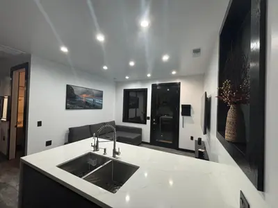 a kitchen with a sink and a living room at Burbank - Starlight Hills Private Luxury Guest House in Burbank