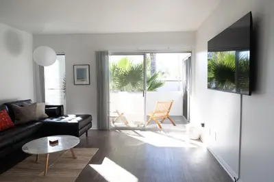 a living room with a couch and a table at King Bed, Gym, Hot Tub, Parking in Thousand Oaks