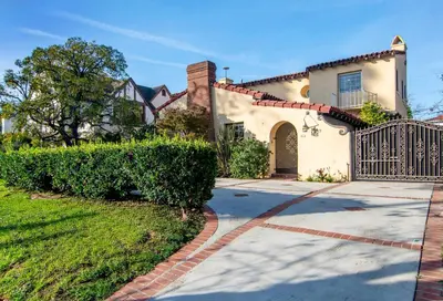 a house with a gate and a driveway at Spacious 4BR Spanish Villa In Hancock Park in Los Angeles
