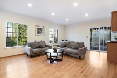 a living room with two couches and a table at Spacious 4BR Spanish Villa In Hancock Park in Los Angeles