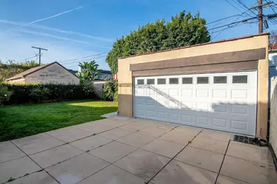 a garage door on a wall with a driveway at Spacious 4BR Spanish Villa In Hancock Park in Los Angeles