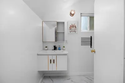 a white bathroom with a sink and a mirror at Pasadena Charming Vacation Home with Hot Jacuzzi in Pasadena