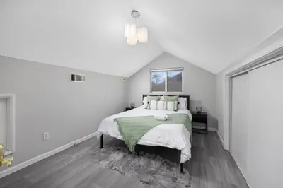 a white bedroom with a bed and a window at Pasadena Charming Vacation Home with Hot Jacuzzi in Pasadena