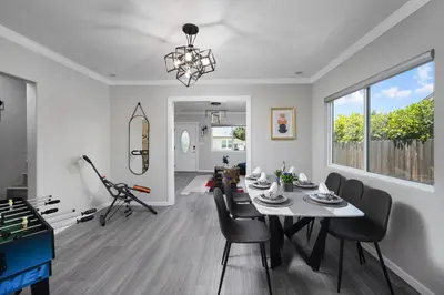 a dining room and living room with a table and chairs at Pasadena Charming Vacation Home with Hot Jacuzzi in Pasadena