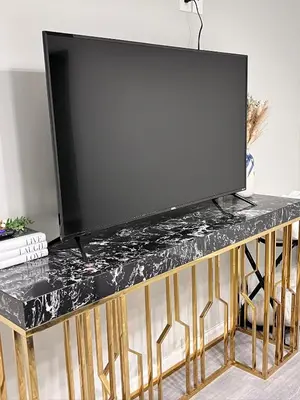 a flat screen tv on a black marble table at Pasadena Charming Vacation Home with Hot Jacuzzi in Pasadena