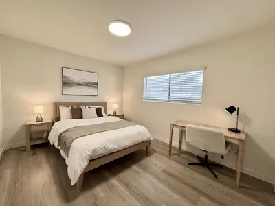 a bedroom with a bed and a desk and a window at Private Flat 15 min to Pasadena, DTLA, JPL in Alhambra