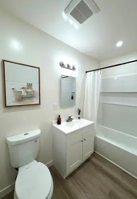 a white bathroom with a toilet and a sink at Private Flat 15 min to Pasadena, DTLA, JPL in Alhambra