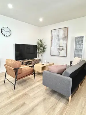 a living room with a couch and a flat screen tv at Private Flat 15 min to Pasadena, DTLA, JPL in Alhambra