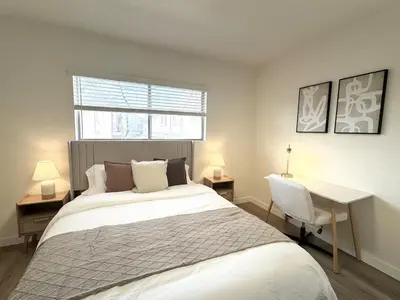 a bedroom with a bed and a desk and a window at Private Flat 15 min to Pasadena, DTLA, JPL in Alhambra
