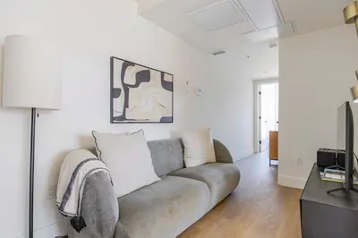 a living room with a couch and a tv at Blueground East Hollywood balcony nr Echo Park LAX-1336 in Los Angeles