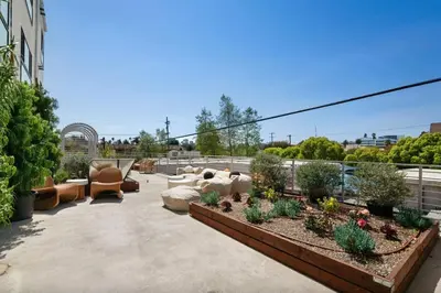 a patio with furniture and plants on a building at Blueground East Hollywood rooftop nr Griffith Park LAX-1337 in Los Angeles