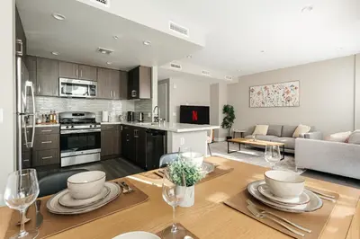 a kitchen and living room with a table and a dining room at Excellent Town Home 2BR in WEHO Parking,Gym,Pool in Los Angeles