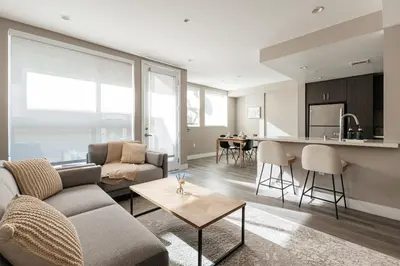 a living room with a couch and a table at Excellent Town Home 2BR in WEHO Parking,Gym,Pool in Los Angeles