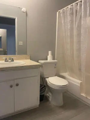 a white bathroom with a toilet and a sink at 3 beds Apart in Beverly Hills in Los Angeles