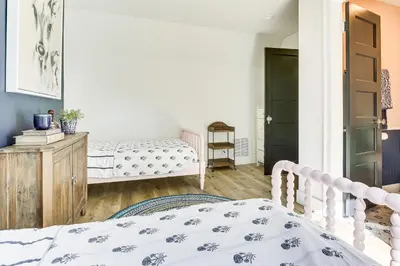 a bedroom with two beds and a door at Walk to Lake Arrowhead Village! Home with Lake Views in Lake Arrowhead