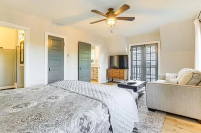 a bedroom with a bed and a ceiling fan at Steps to Lake Arrowhead Village Chic Apartment in Lake Arrowhead