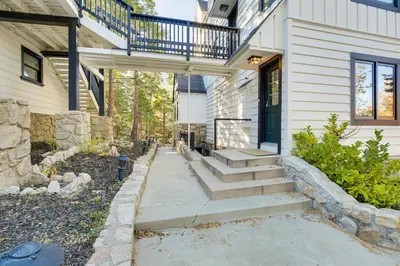 a walkway leading to a house with a balcony at Steps to Lake Arrowhead Village Chic Apartment in Lake Arrowhead
