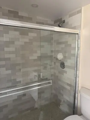 a bathroom with a glass shower with a toilet at Peaceful Cottage in Vermont Knolls in Los Angeles