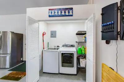 a kitchen with a washing machine and a refrigerator at Surreal Feel Lakeview #B (Upstairs) in Lake Arrowhead