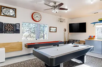 a living room with a pool table and a clock at Surreal Feel Lakeview #B (Upstairs) in Lake Arrowhead