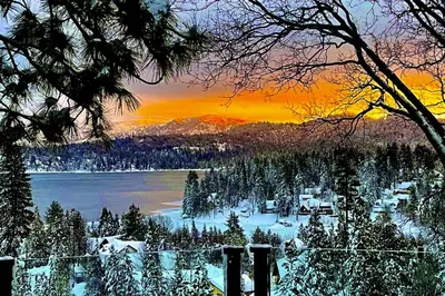 a winter view of a lake with snow and trees at Surreal Feel Lakeview #B (Upstairs) in Lake Arrowhead