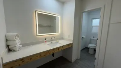a bathroom with a sink and a mirror and a toilet at Florentine Motel And Studio in Bell