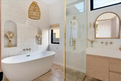 a bathroom with a large white tub and a sink at Bohemian Dream Studio Close to LA Stadium SOFI Kia Forum Intuit Dome LA Coliseum in Los Angeles