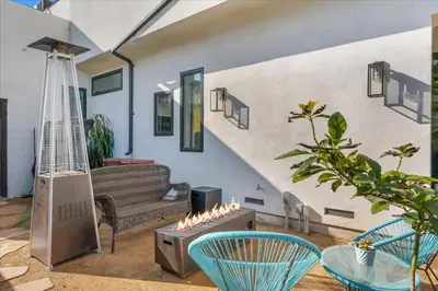 a living room with a couch and chairs and a staircase at Bohemian Dream Studio Close to LA Stadium SOFI Kia Forum Intuit Dome LA Coliseum in Los Angeles