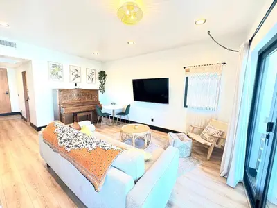 a living room with a couch and a piano at Bohemian Dream Studio Close to LA Stadium SOFI Kia Forum Intuit Dome LA Coliseum in Los Angeles