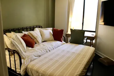 a bed with pillows on it in a room at Designer Light-Filled WeHo Condo in Los Angeles
