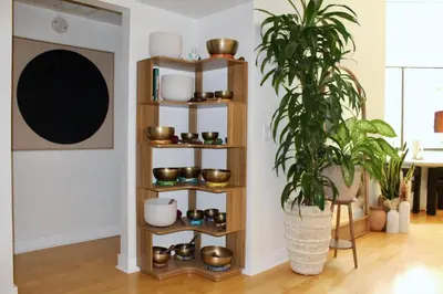 a wooden shelf in a living room with a plant at Designer Light-Filled WeHo Condo in Los Angeles
