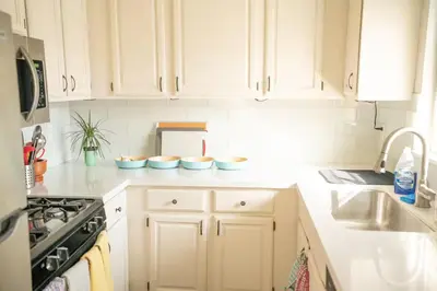 a kitchen with white cabinets and blue bowls on the counter at Bright and Comfortable 2 Bedrooms with Views in Santa Monica in Los Angeles
