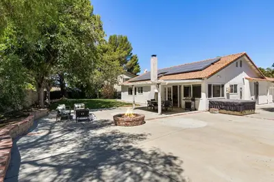 a house with a fire pit in the yard at Cozy & Bright Santa Clarita Retreat in Santa Clarita