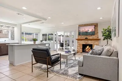 a kitchen and living room with a fireplace at Cozy & Bright Santa Clarita Retreat in Santa Clarita