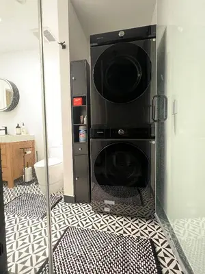 a black washer and dryer in a bathroom at Newly Built Private Guest House in Glendale