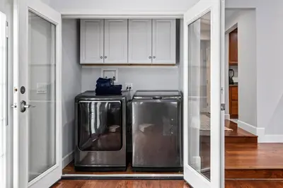a laundry room with two stainless steel washer and dryer at Luxury home w/ yard + parking in Newhall