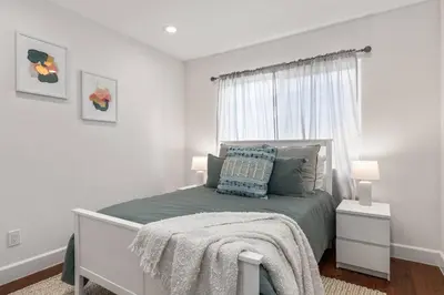 a white bedroom with a bed and a window at Luxury home w/ yard + parking in Newhall