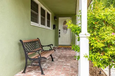 a bench sitting on the porch of a house at Luxury home w/ yard + parking in Newhall