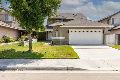 a house with a white garage in a yard at Luxury Modern Home w/ Jacuzzi | GOODE HOMES in Santa Clarita