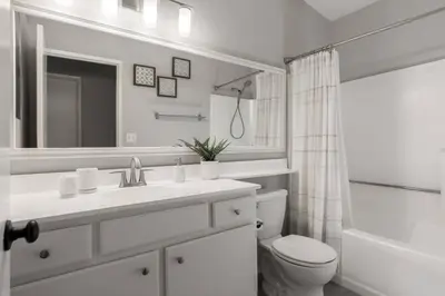 a white bathroom with a sink and a toilet at Luxury Modern Home w/ Jacuzzi | GOODE HOMES in Santa Clarita