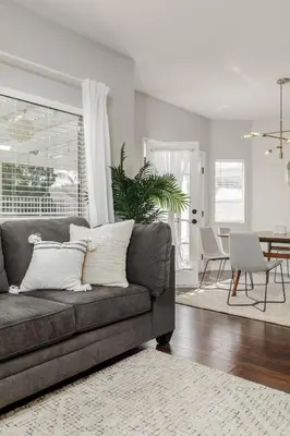 a living room with a couch and a dining room at Luxury Modern Home w/ Jacuzzi | GOODE HOMES in Santa Clarita