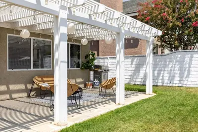 a white pergola with a table and chairs on a patio at Luxury Modern Home w/ Jacuzzi | GOODE HOMES in Santa Clarita