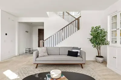 a living room with a couch and a staircase at Luxury Mountain View Home w/ large backyard in Santa Clarita