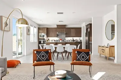 a living room with a table and chairs and a kitchen at Luxury Mountain View Home w/ large backyard in Santa Clarita